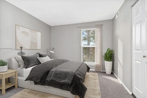 Model bedroom with large window for natural lighting