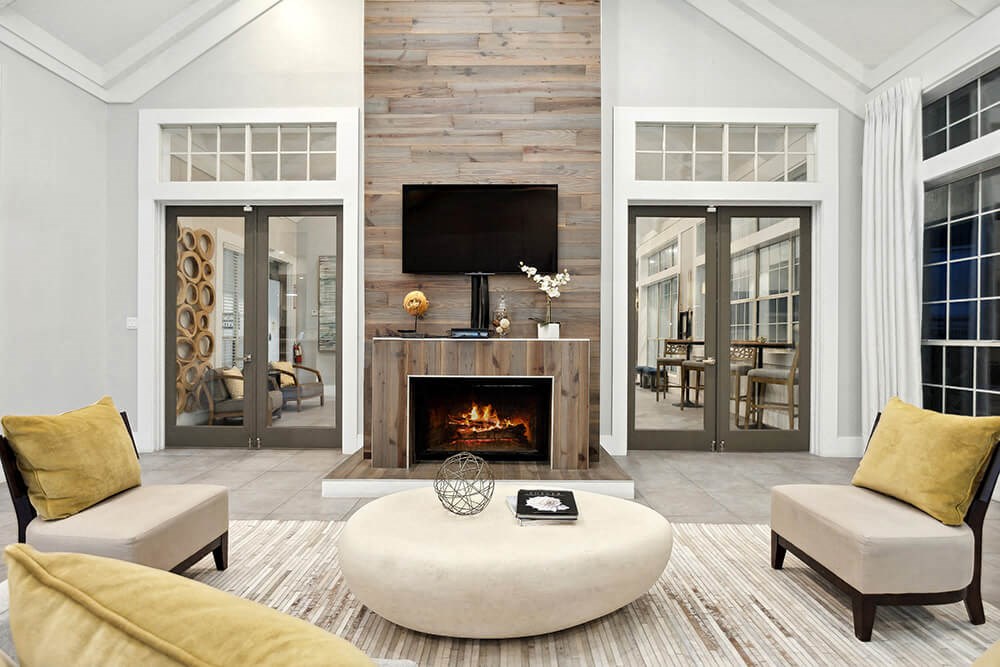 Community Clubhouse with Lounge Furniture and Fireplace at Caribbean Breeze Apartments in Tampa, FL.