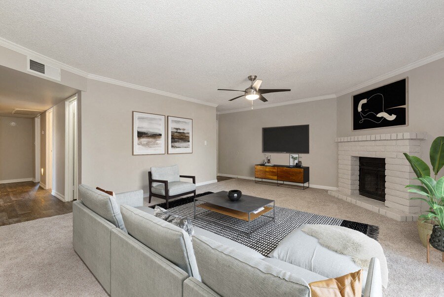 Model apartment living room with a couch and a tv at Saratoga Ridge, Arizona