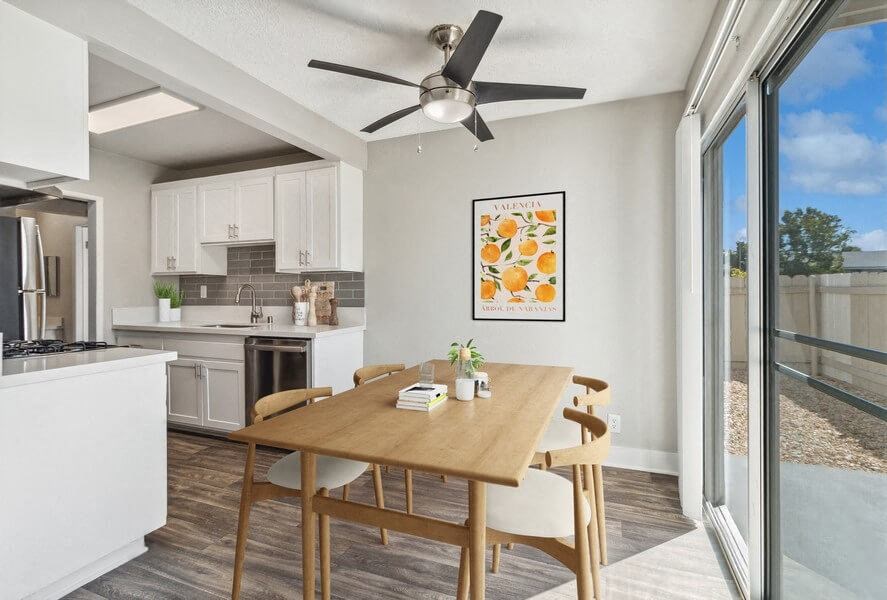 Model Dining Room with Wood-Style Flooring & View of Kitchen at Forest Park Apartments in El Cajon, CA.