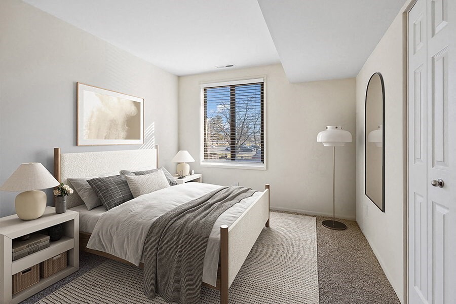 Model Bedroom with Carpet and Window View at Spring Parc Apartments in Silver Spring, MD.