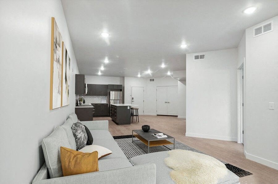Model living room with view of kitchen