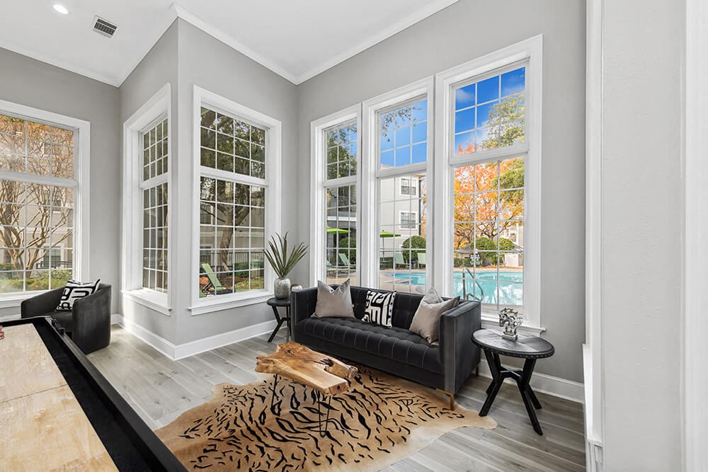 Community Clubhouse with Lounge Furniture and Game Tables at Bridges at Oakbend Apartments in Lewisville, TX.