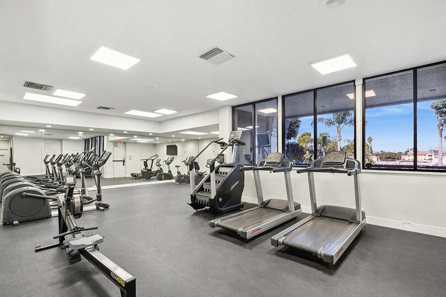 Community Fitness Center with Equipment at Madison Park Apartments located in Anaheim, CA.