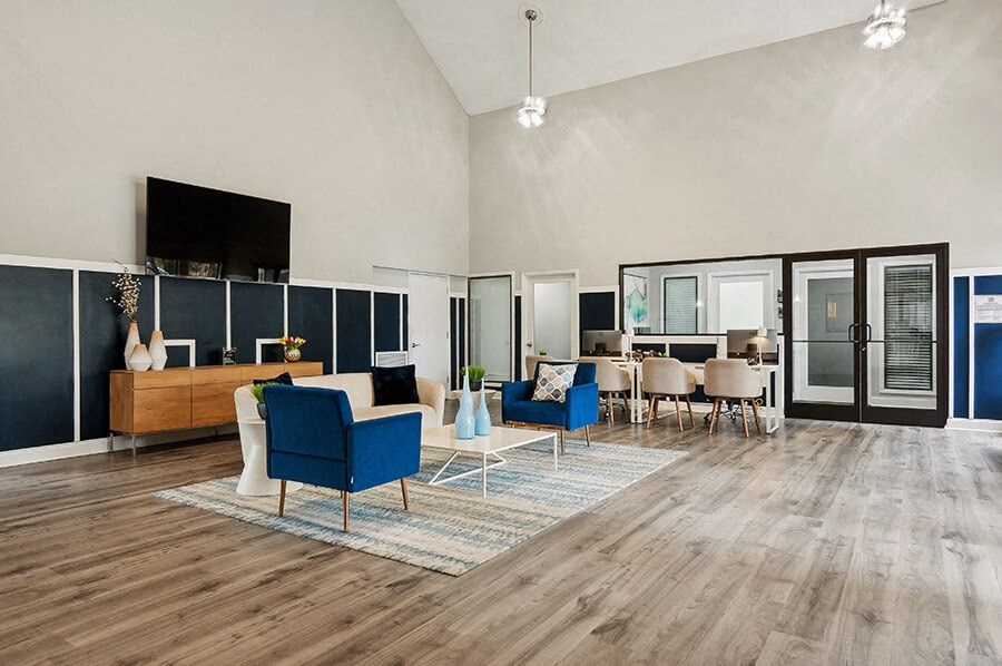 Community Clubhouse with Lounge Furniture and TV at Park 2300 Apartments in Charlotte, NC.