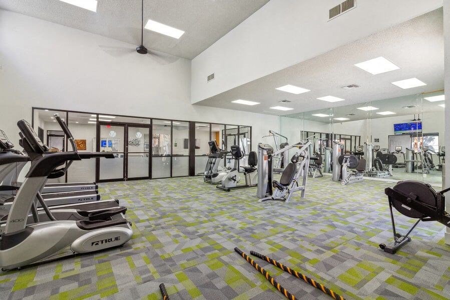 a gym with treadmills and other exercise equipment