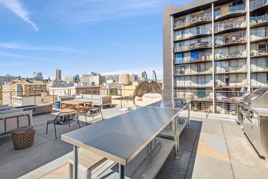 Outdoor kitchen space with BBQ grills at TL Residences