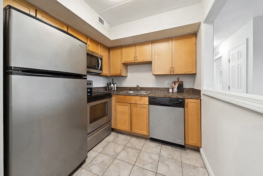Model Kitchen with Tile Flooring and Oak Cabinets at Heights Marlborough Apartments in Boston, MA.