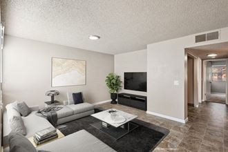 Model Living Room with Wood-Style Flooring at Bella Vista Apartments in St. George, Utah.
