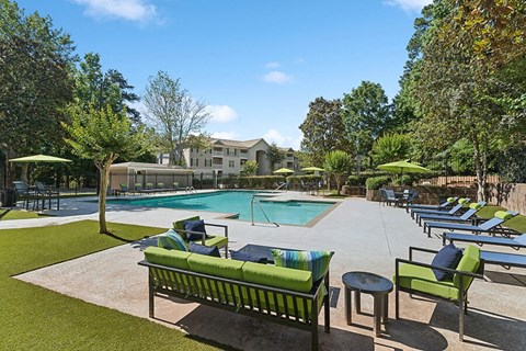 Community Swimming Pool with Pool Furniture at Retreat at Stonecrest Apartments located in Lithonia, GA.