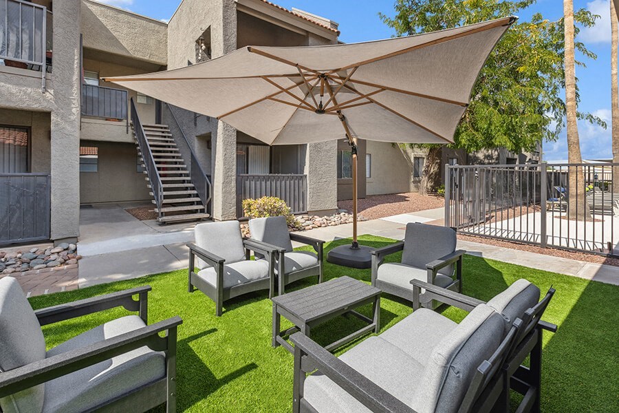 Outdoor Lounge Area with Covered Furniture at Saddle Ridge Apartments in Tucson, AZ.