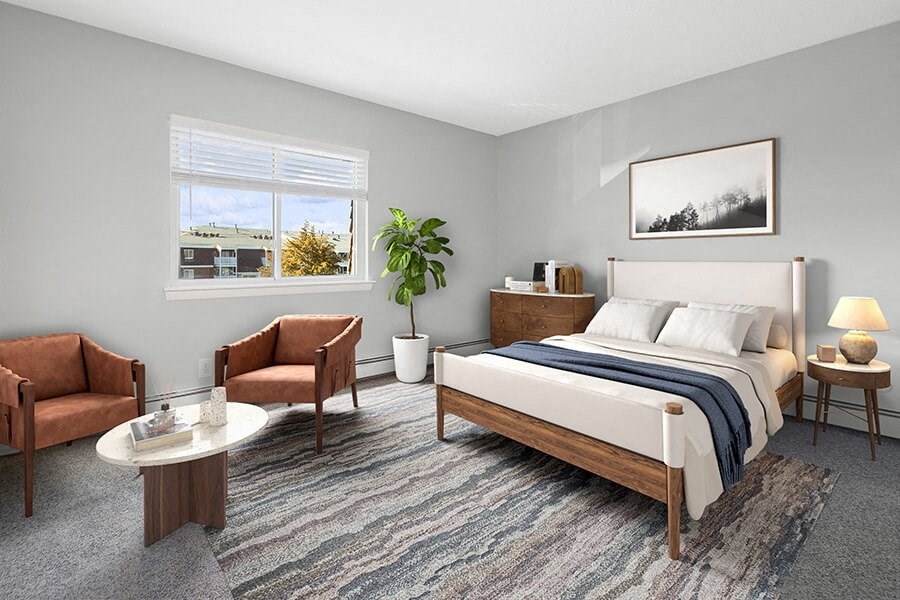 Model Bedroom with Carpet and Window View at Stone Ends Apartments in Stoughton, MA.