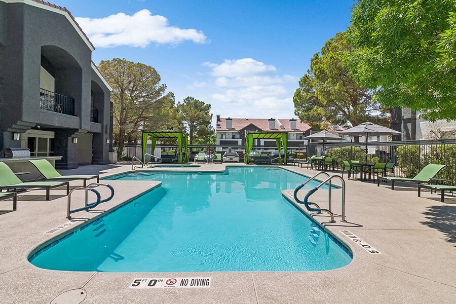 Community Swimming Pool with Pool Furniture at Meadow Ridge Apartments located in Las Vegas, NV.