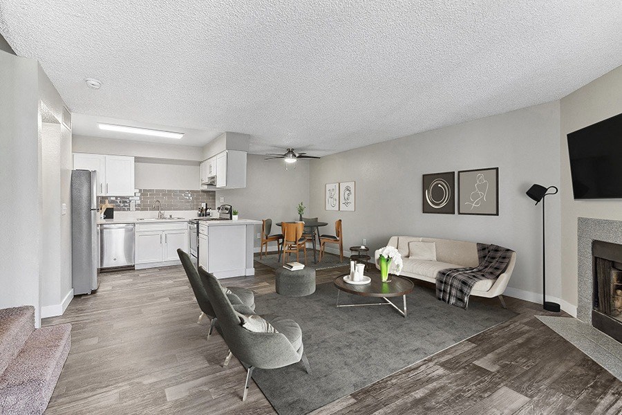 Model Living Room with Wood-Style Flooring and Fireplace at Meadow Ridge Apartments in Las Vegas, NV.