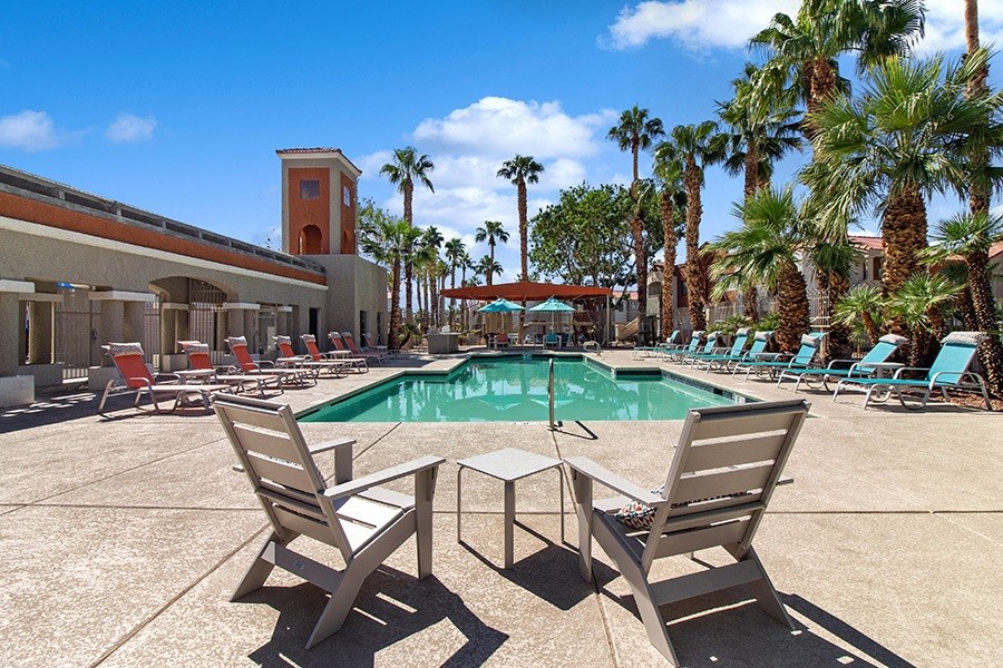 Community Swimming Pool with Pool Furniture at Stonegate Apartments in Las Vegs, NV.