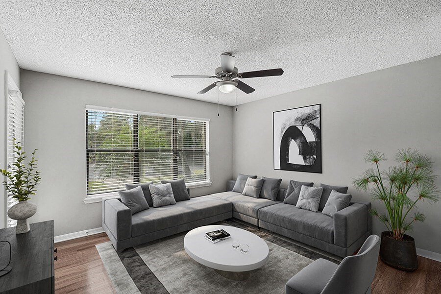 Model Living Room with Wood-Style Flooring and Patio Accessibility at Fountains Lee Vista Apartments in Orlando, FL.