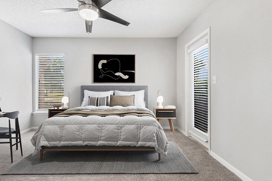 Model Bedroom with Carpet and Patio Accessibility at Rosehill Preserve Apartments located in Orlando, FL.