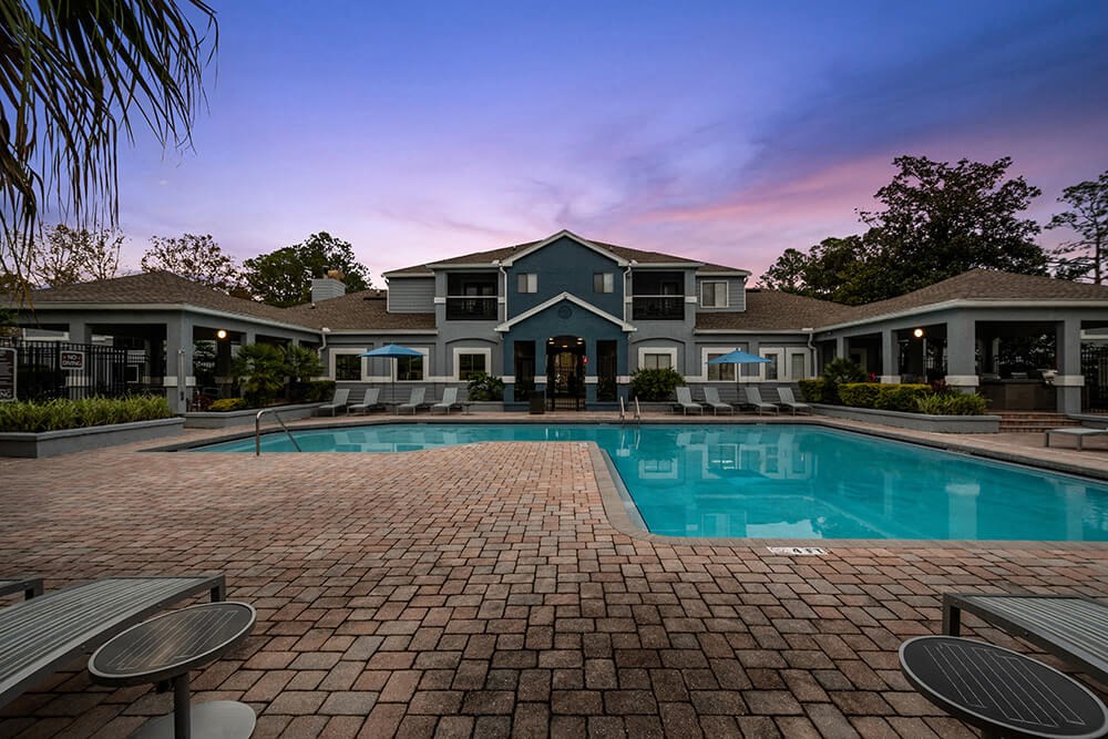 Community Swimming Pool with Pool Furniture at Westland Park Apartments in Jacksonville, FL.