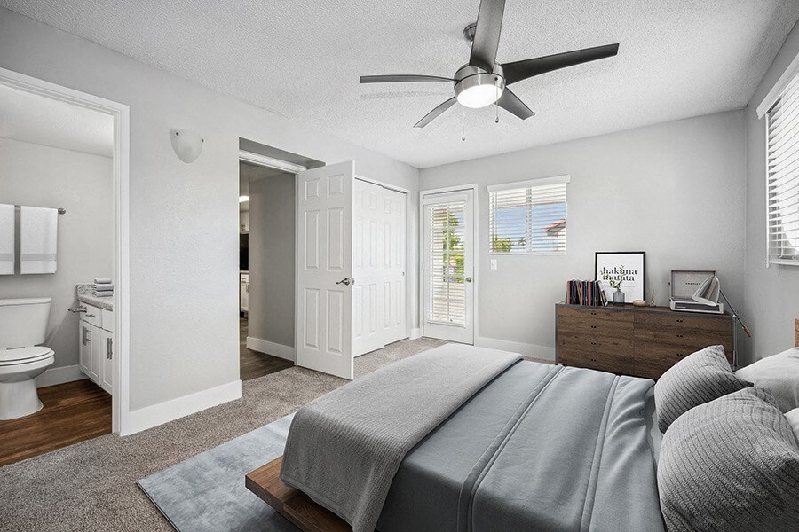 Model Bedroom with Carpet and attached Bathroom at Stillwater Apartments located in Glendale, AZ.