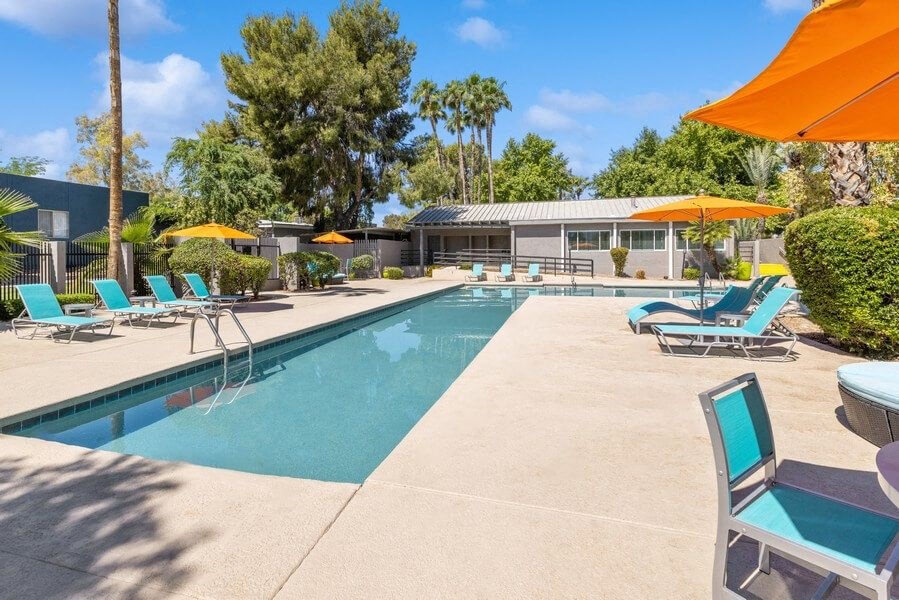 Community Swimming Pool with Pool Furniture at Lakeside Casitas Apartments in Tucson, AZ.