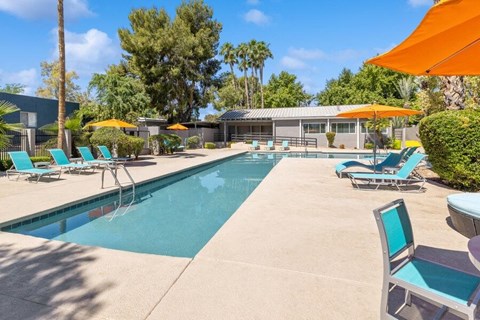 Community Swimming Pool with Pool Furniture at Lakeside Casitas Apartments in Tucson, AZ.