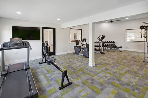 A gym with exercise equipment and a flat screen tv at Lakeside Casitas in Tucson, AZ