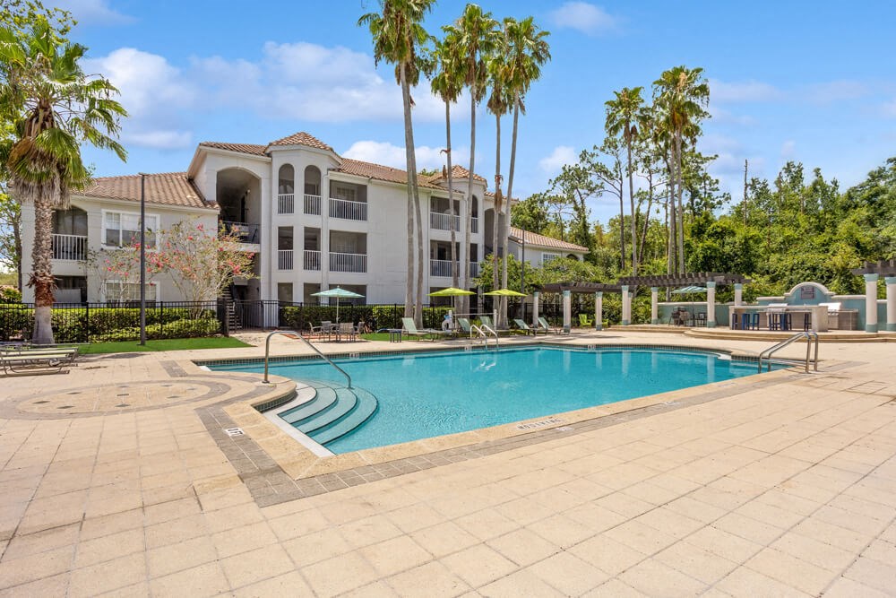Swimming pool and pool deck with apartment building in background