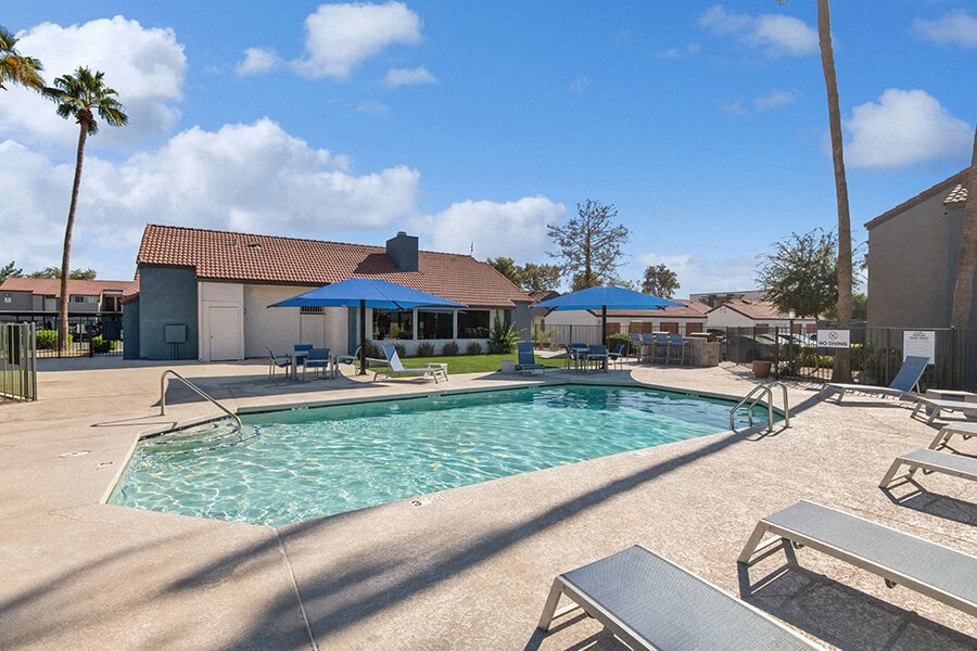 Community Swimming Pool with Pool Furniture at Peaks on 4th Apartments in Avondale, AZ.