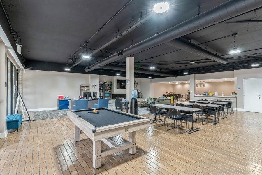 Clubhouse game room with pool table