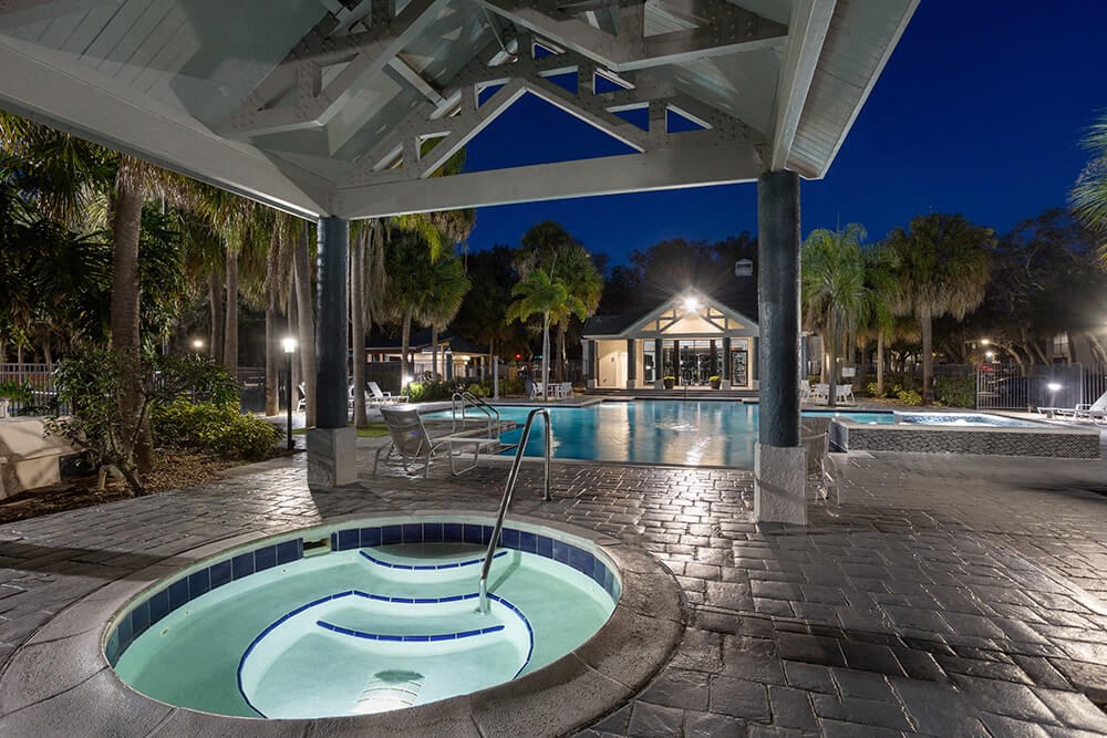 Community Swimming Pool with Pool Furniture at Caribbean Breeze Apartments in Tampa, FL.