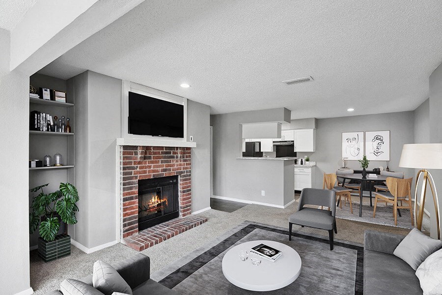 Model Living Room with Carpet and View of Kitchen/Dining Area at Abbington Heights Apartments in Antioch, TN.