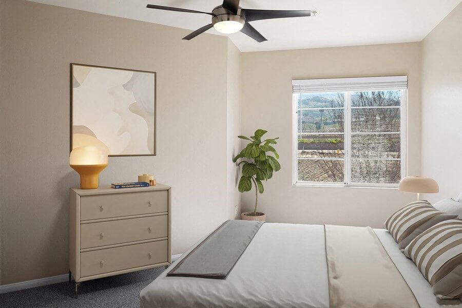 Model bedroom with ceiling fan at Reserve at Rancho Apartments
