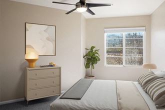 Model bedroom with ceiling fan at Reserve at Rancho Apartments - Photo Gallery