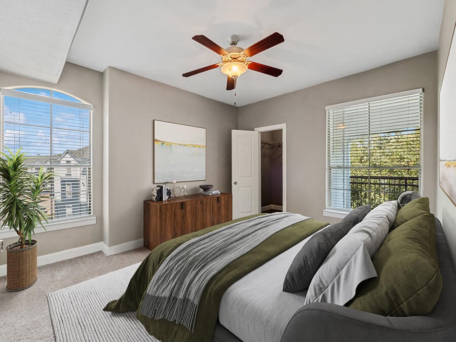Model Bedroom with Carpet and Window Views at Park West Apartments located in Houston, TX.