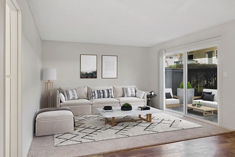 A living room with a white couch and a coffee table.