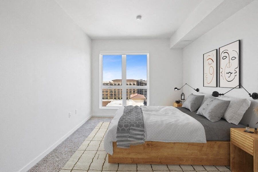 Model bedroom with carpeting and extra large window