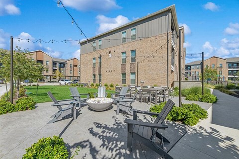 Outdoor Fire Pit Area and Lounge Furniture at Alta 3Eighty Apartments located in Aubrey, TX.
