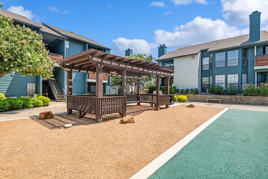 Outdoor Covered Seating Area at Bridges at Deer Run Apartments in Dallas, TX.