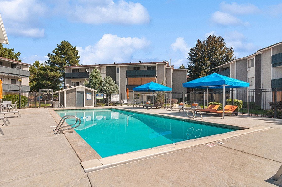 Community Swimming Pool with Pool Furniture at Monaco Apartments in Salt Lake City, UT.