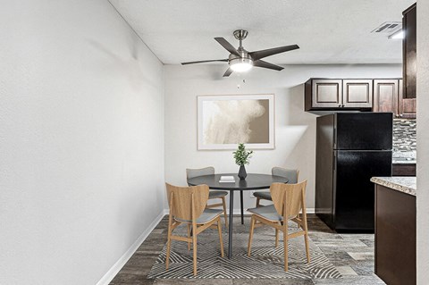 our apartments have a dining table and a kitchen with a refrigerator