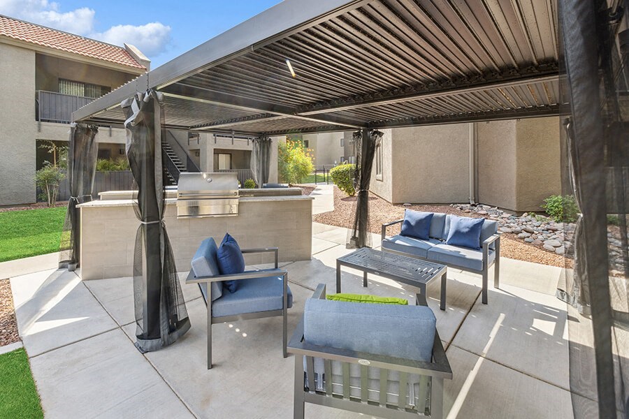 Outdoor BBQ Area with Furniture and Canopy at Saddle Ridge Apartments in Tucson, AZ.