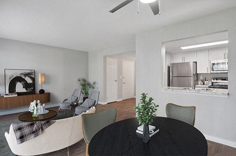 Model Living/Dining Room with Wood-Style Flooring and View of Kitchen at Overlook Point Apartments in Salt Lake City, UT.