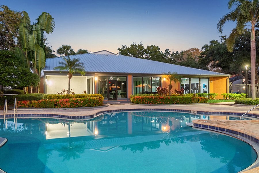 Community Swimming Pool with Pool Furniture at Bridges at Bayside Apartments in St. Petersburg, FL.