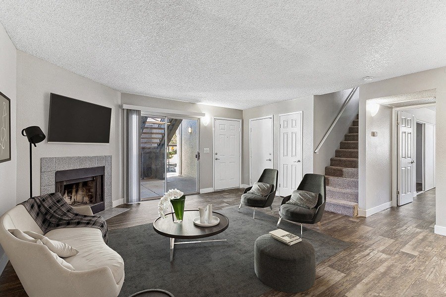 Model Living Room with Wood-Style Flooring and Patio Accessibility at Meadow Ridge Apartments in Las Vegas, NV.