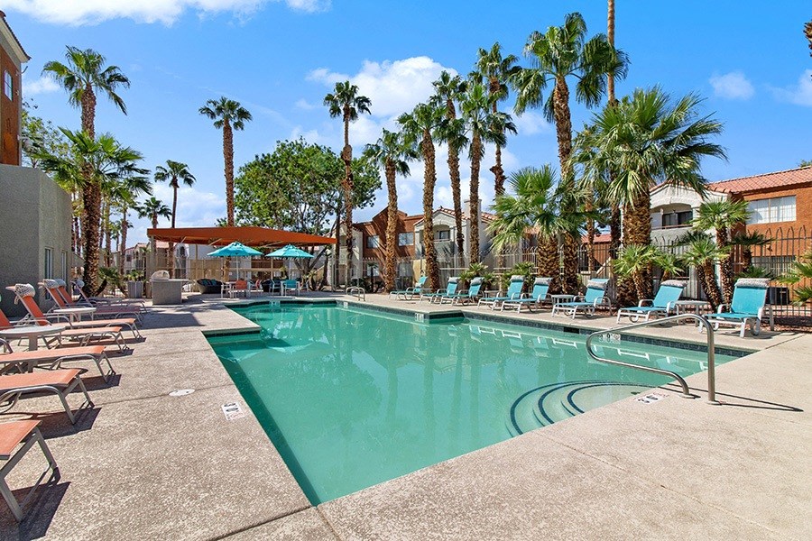 Community Swimming Pool with Pool Furniture at Stonegate Apartments in Las Vegs, NV.