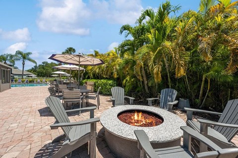 Community Fire Pit Area with Patio Furniture at Waverley Place Apartments in Naples, FL.