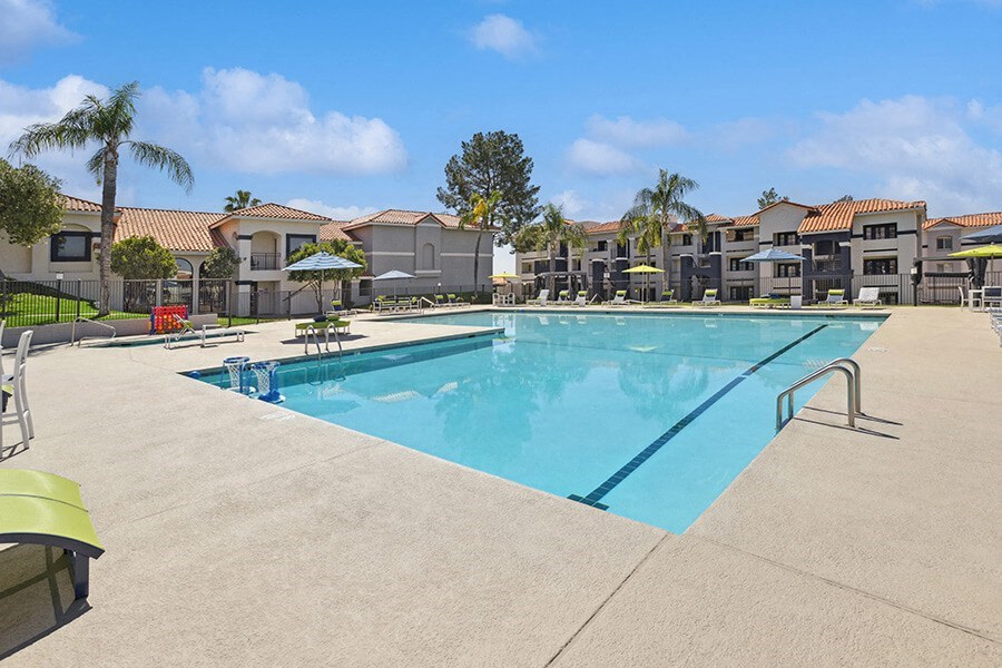 Community Swimming Pool with Pool Furniture at Hilands Apartments in Tucson, AZ.