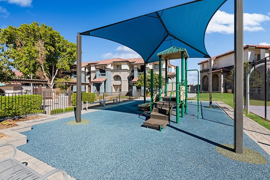 Community Playground with Blue Canopy at Stillwater Apartments in Glendale, AZ.