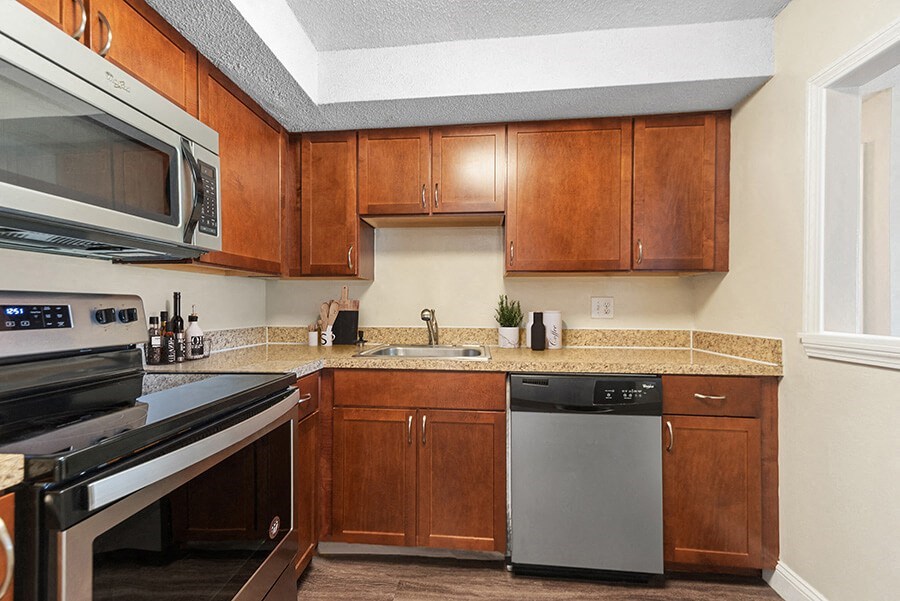 Model Kitchen with Brown Cabinets and Tile at Meadows at Marlborough Apartments in Boston, MA.