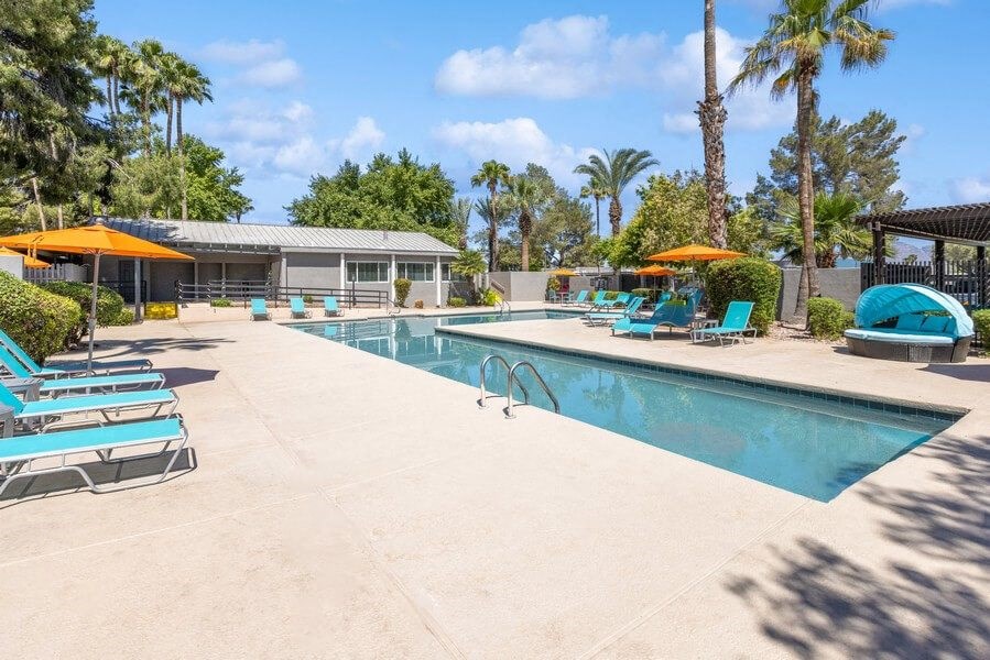 Community Swimming Pool with Pool Furniture at Lakeside Casitas Apartments in Tucson, AZ.